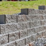 Retaining wall is being built as part of construction new home near property where wall is to be built